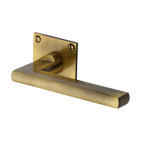 This is an image of a Heritage Brass - Door Handle Lever Latch on Square Rose Trident Design Antique finish, bau2910-at that is available to order from Trade Door Handles in Kendal.