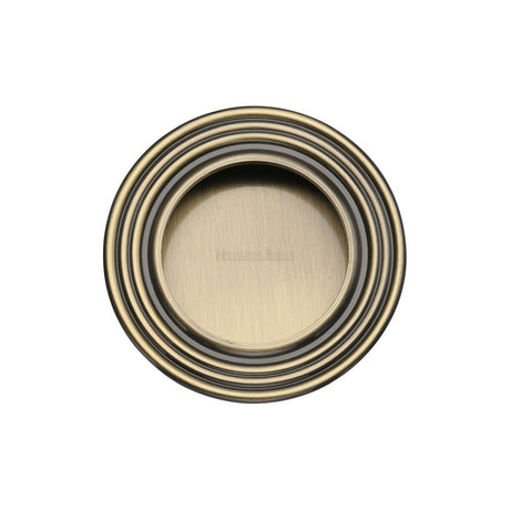 This is an image of a Heritage Brass - Round Reeded Flush Pull Antique Brass Finish, c1837-at that is available to order from Trade Door Handles in Kendal.