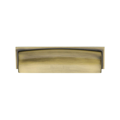 This is an image of a Heritage Brass - Drawer Cup Pull Shropshire Design 76/96mm CTC Antique Brass Finish, c2765-96-at that is available to order from Trade Door Handles in Kendal.