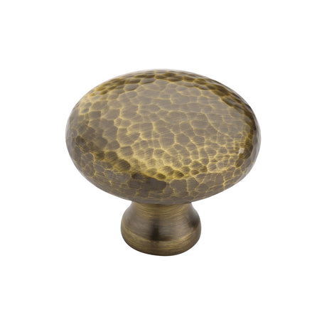 This is an image of a Heritage Brass - Cabinet Knob Victorian Round Hammered Design 38mm Antique Brass finish, ham113-38-at that is available to order from Trade Door Handles in Kendal.