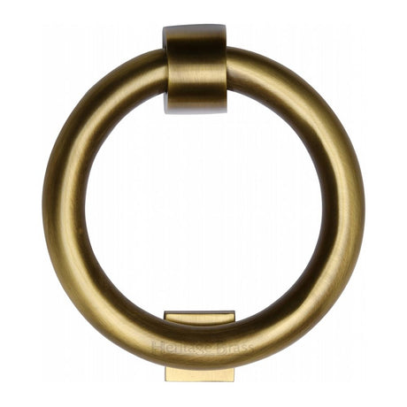 This is an image of a Heritage Brass - Ring Knocker Antique Brass Finish, k1270-at that is available to order from Trade Door Handles in Kendal.