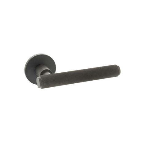 This is an image of Millhouse Brass Stephenson Designer Lever on 5mm Slimline Round Rose - Urban Dar available to order from Trade Door Handles.