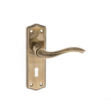 This is an image of Old English Warwick Key Lever on Backplate - Antique Brass available to order from Trade Door Handles.