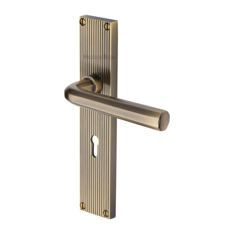 This is an image of a Heritage Brass - Octave Reeded Lever Lock Antique Brass finish, rr3700-at that is available to order from Trade Door Handles in Kendal.