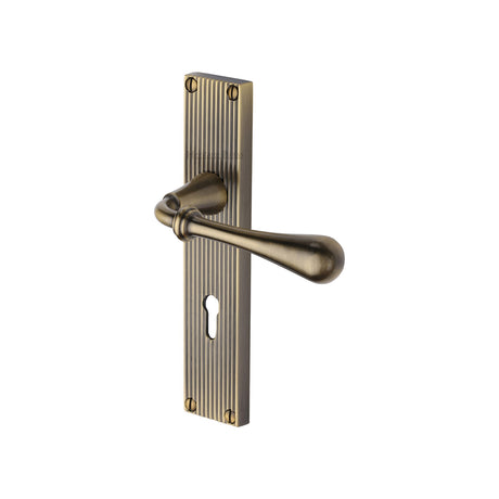 This is an image of a Heritage Brass - Roma Reeded Lever Lock Antique Brass finish, rr6000-at that is available to order from Trade Door Handles in Kendal.
