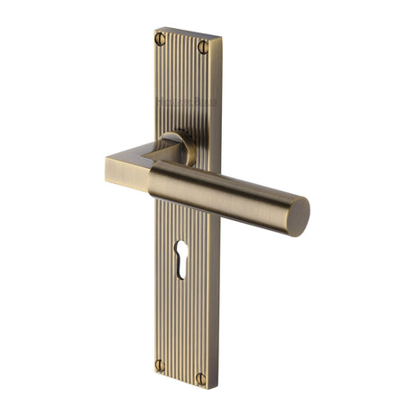 This is an image of a Heritage Brass - Bauhaus Reeded Lever Lock Antique Brass finish, rr7300-at that is available to order from Trade Door Handles in Kendal.