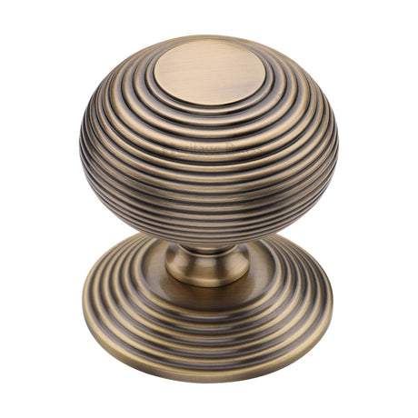 This is an image of a Heritage Brass - Centre Door Knob Reeded Design 3 1/2 Antique Brass Finish, rr906-at that is available to order from Trade Door Handles in Kendal.