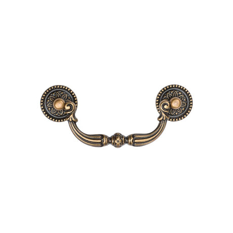 This is an image of a M.Marcus - Ornate Drop Pull 96mm Distressed Brass Finish, tk3085-096-dbs that is available to order from Trade Door Handles in Kendal.
