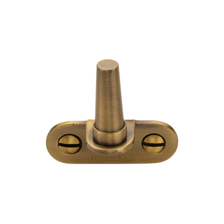This is an image of a Heritage Brass - Cranked Casement Stay Pin Antique Brass finish, v1002-at that is available to order from Trade Door Handles in Kendal.