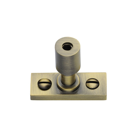 This is an image of a Heritage Brass - Casement Stay Locking Pin Antique Brass, v1007-at that is available to order from Trade Door Handles in Kendal.
