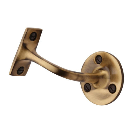 This is an image of a Heritage Brass - Handrail Bracket 3" Antique Brass Finish, v1030-76-at that is available to order from Trade Door Handles in Kendal.