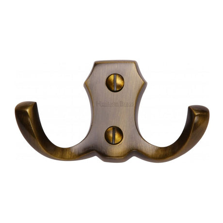 This is an image of a Heritage Brass - Double Coat Hook Antique Brass Finish, v1062-at that is available to order from Trade Door Handles in Kendal.