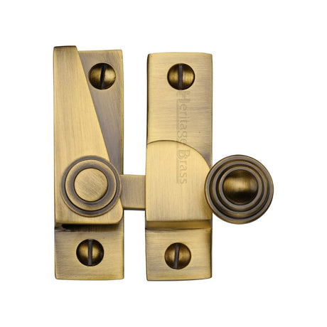 This is an image of a Heritage Brass - Sash Fastener Antique Brass Finish, v1104-at that is available to order from Trade Door Handles in Kendal.