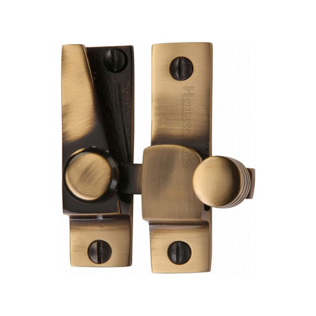 This is an image of a Heritage Brass - Sash Fastener Antique Brass Finish, v1105-at that is available to order from Trade Door Handles in Kendal.