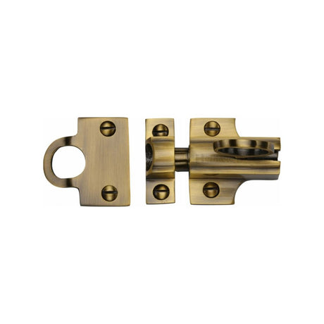 This is an image of a Heritage Brass - Fanlight Catch Antique Brass Finish, v1117-at that is available to order from Trade Door Handles in Kendal.
