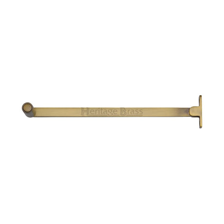 This is an image of a Heritage Brass - Roller Arm Stay 254mm Antique Brass Finish, v1119-10-at that is available to order from Trade Door Handles in Kendal.
