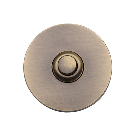 This is an image of a Heritage Brass - Round Bell Push Antique Brass finish, v1184-at that is available to order from Trade Door Handles in Kendal.