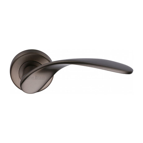 This is an image of a Heritage Brass - Door Handle Lever Latch on Round Rose Volo Design Matt Bronze finish, v1950-mb that is available to order from Trade Door Handles in Kendal.