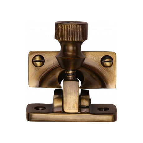 This is an image of a Heritage Brass - Brighton Sash Fastener Antique Brass Finish, v2055-at that is available to order from Trade Door Handles in Kendal.