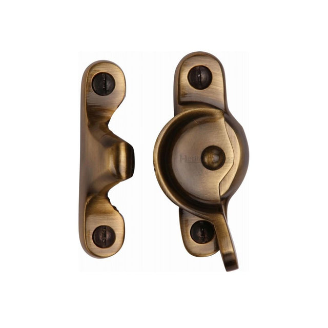 This is an image of a Heritage Brass - Fitch Pattern Sash Fastener Antique Brass Finish, v2060-at that is available to order from Trade Door Handles in Kendal.