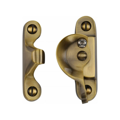 This is an image of a Heritage Brass - Fitch Pattern Sash Fastener Lockable Antique Brass Finish, v2060l-at that is available to order from Trade Door Handles in Kendal.