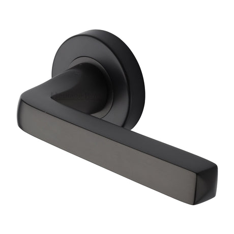 This is an image of a Heritage Brass - Alessa Door Handle on Round Rose Matt Bronze finish, v8300-mb that is available to order from Trade Door Handles in Kendal.