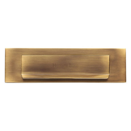 This is an image of a Heritage Brass - Gravity Letterplate 280 x 80mm - Antique Brass Finish, v842-at that is available to order from Trade Door Handles in Kendal.