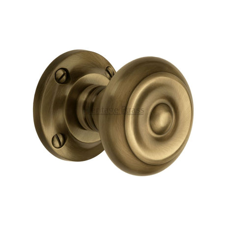 This is an image of a Heritage Brass - Mortice Knob on Rose Aylesbury Design Antique Brass Finish, v872-at that is available to order from Trade Door Handles in Kendal.