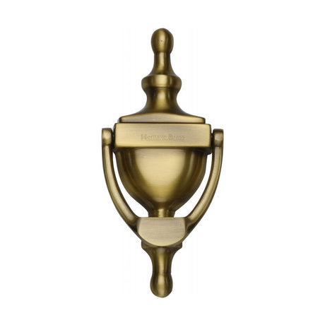 This is an image of a Heritage Brass - Urn Knocker 6" Antique Brass Finish, v910-152-at that is available to order from Trade Door Handles in Kendal.
