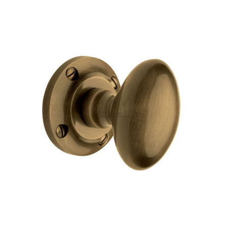 This is an image of a Heritage Brass - Mortice Knob on Rose Suffolk Design Antique Brass Finish, v960-at that is available to order from Trade Door Handles in Kendal.