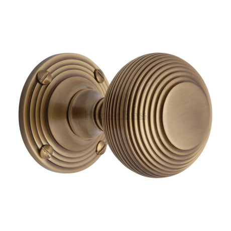 This is an image of a Heritage Brass - Mortice Knob on Rose Reeded Design Antique Brass Finish, v971-at that is available to order from Trade Door Handles in Kendal.