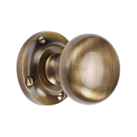 This is an image of a Heritage Brass - Mortice Knob on Rose Victoria Design Antique Brass Finish, v980-at that is available to order from Trade Door Handles in Kendal.
