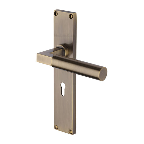 This is an image of a Heritage Brass - Bauhaus Lever Lock Door Handle on 200mm Plate Antique Brass finish, vt6300-at that is available to order from Trade Door Handles in Kendal.