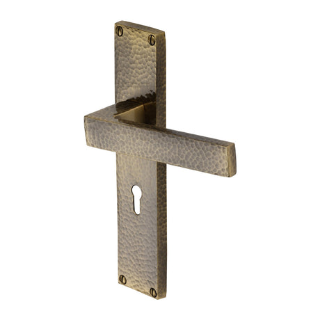 This is an image of a Heritage Brass - Delta Hammered Lever Lock Door Handle on 200mm Plate Antique Brass finish, vth3300-at that is available to order from Trade Door Handles in Kendal.