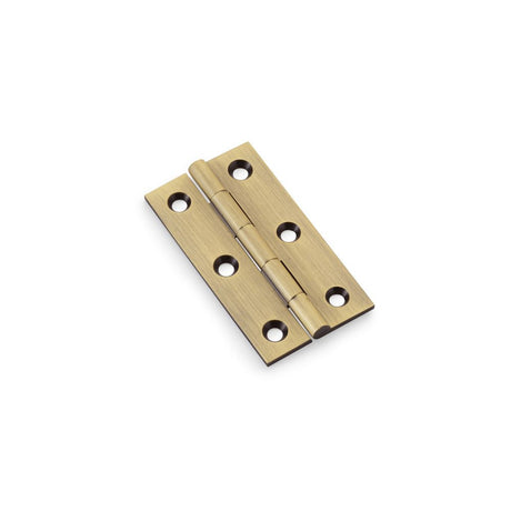 This is an image showing Alexander & Wilks Heavy Pattern Solid Brass Cabinet Butt Hinge - Antique Brass - 2.5" aw064-ch-ab available to order from Trade Door Handles in Kendal, quick delivery and discounted prices.