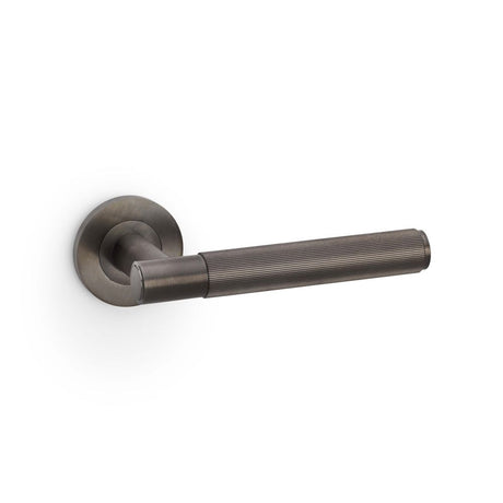 This is an image showing Alexander & Wilks Spitfire Reeded Lever on Round Rose - Dark Bronze PVD aw222dbzpvd available to order from Trade Door Handles in Kendal, quick delivery and discounted prices.