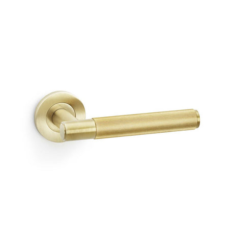 This is an image showing Alexander & Wilks Spitfire Reeded Lever on Round Rose - Satin Brass PVD aw222sbpvd available to order from Trade Door Handles in Kendal, quick delivery and discounted prices.