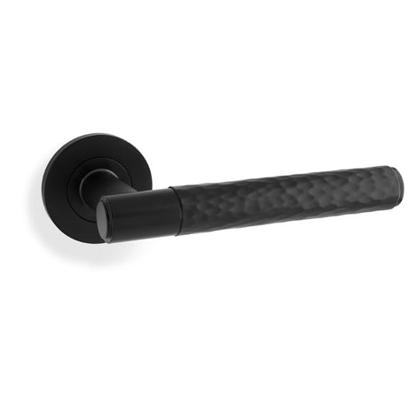 This is an image showing Alexander & Wilks Spitfire Hammered Lever on Round Rose - Black aw223bl available to order from Trade Door Handles in Kendal, quick delivery and discounted prices.