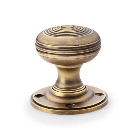 This is an image showing Alexander & Wilks Christoph Mortice Knob - Antique Brass aw303-50-ab available to order from Trade Door Handles in Kendal, quick delivery and discounted prices.