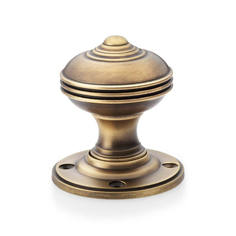 This is an image showing Alexander & Wilks Romeo Mortice Knob - Antique Brass aw304-50-ab available to order from Trade Door Handles in Kendal, quick delivery and discounted prices.