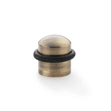 This is an image showing Alexander & Wilks Dome Top Floor Mounted Door Stop - Antique Bronze aw638abz available to order from Trade Door Handles in Kendal, quick delivery and discounted prices.