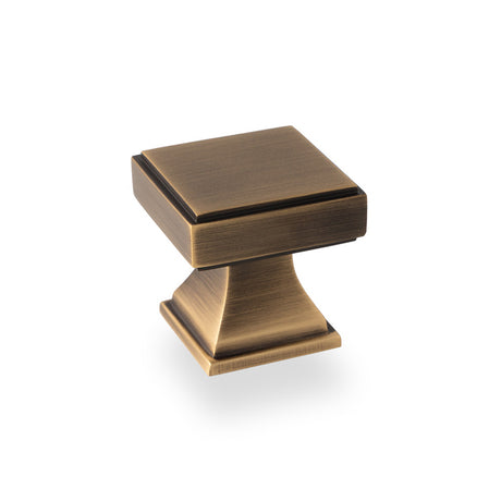 This is an image showing Alexander & Wilks Jesper Square Cupboard Knob - Antique Brass aw806-30-ab available to order from Trade Door Handles in Kendal, quick delivery and discounted prices.