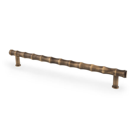 This is an image showing Alexander & Wilks Crispin Bamboo T-bar Cupboard Pull Handle - Antique Brass - 224mm Centres aw809b-224-ab available to order from Trade Door Handles in Kendal, quick delivery and discounted prices.
