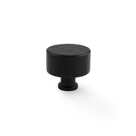 This is an image showing Alexander & Wilks Leila Hammered Cupboard Knob - Black - 35mm aw816-35-bl available to order from Trade Door Handles in Kendal, quick delivery and discounted prices.