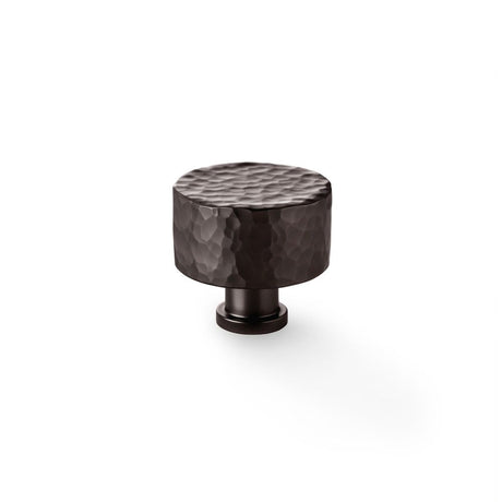 This is an image showing Alexander & Wilks Leila Hammered Cupboard Knob - Dark Bronze - 35mm aw816-35-dbz available to order from Trade Door Handles in Kendal, quick delivery and discounted prices.