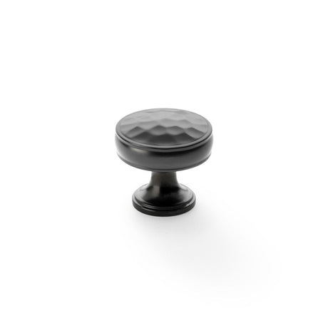 This is an image showing Alexander & Wilks Lynd Hammered Cupboard Knob - Dark Bronze - 32mm aw818-32-dbz available to order from Trade Door Handles in Kendal, quick delivery and discounted prices.