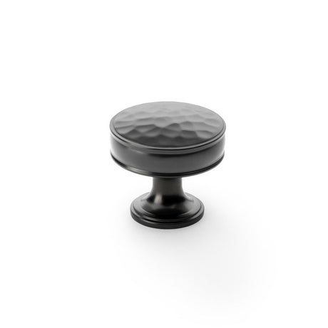 This is an image showing Alexander & Wilks Lynd Hammered Cupboard Knob - Dark Bronze - 38mm aw818-38-dbz available to order from Trade Door Handles in Kendal, quick delivery and discounted prices.