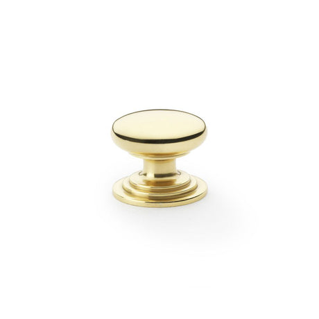This is an image showing Alexander & Wilks Waltz Round Cupboard Knob on Stepped Rose - Polished Brass - 32mm aw825-32-pbl available to order from Trade Door Handles in Kendal, quick delivery and discounted prices.