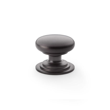 This is an image showing Alexander & Wilks Waltz Round Cupboard Knob on Stepped Rose - Dark Bronze - 38mm aw825-38-dbz available to order from Trade Door Handles in Kendal, quick delivery and discounted prices.