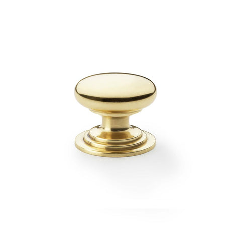 This is an image showing Alexander & Wilks Waltz Round Cupboard Knob on Stepped Rose - Polished Brass - 38mm aw825-38-pbl available to order from Trade Door Handles in Kendal, quick delivery and discounted prices.